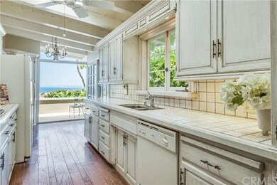 Kitchen boasts ocean and coastline views, gas cook