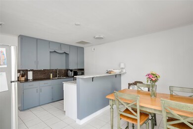 Kitchen featuring a sink, black microwave, freest