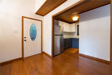 Interior view of the front door and kitchen with n