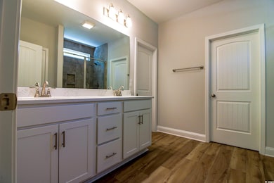 Full bathroom featuring double vanity, a sink, a s