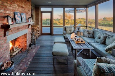 Screened porch with fireplace overlooking the Atlantic Ocean