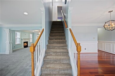 View of front of house featuring asphalt driveway,