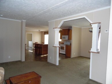 LIVING ROOM TOWARD KITCHEN AND DINING VI