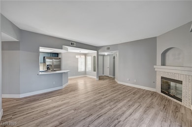 Unfurnished living room featuring a tile fireplace