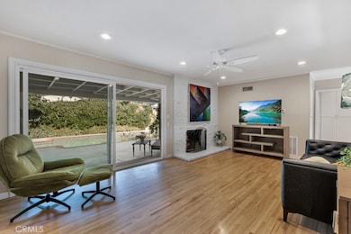 Living Room

Front door with glass inserts
Energy efficient dual pane windows
Smooth ceilings 
Crown molding
Ceiling fan
LED recessed lights
Floor-to-ceiling fireplace in white-painted brick
Oversized sliding glass door leading to the backya