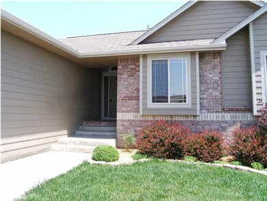 Covered front porch shelters guests.