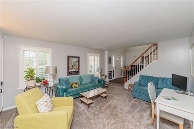 Carpeted living room with a healthy amount of sunlight