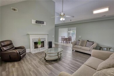 Living room with a fireplace, wood finished floors