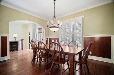 Dining area featuring ornamental molding, a chande