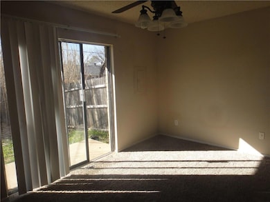 Carpeted spare room featuring ceiling fan