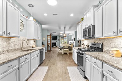 Kitchen with a sink, light wood finished floors, a