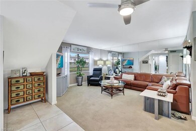 Living room featuring light carpet, ceiling fan, l