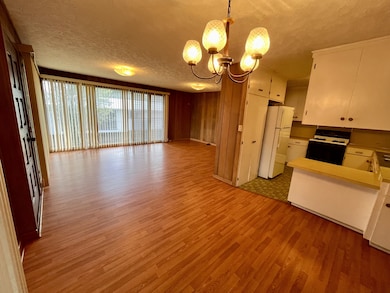 Dining area looking towards living room with the kitchen to the right.
