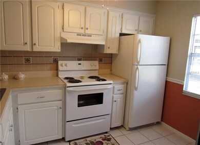 Light and bright kitchen with plenty of cabinets.