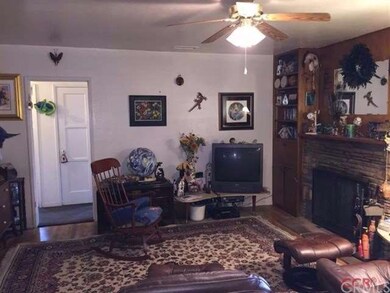 A nice stacked stone fireplace, wood flooring and 