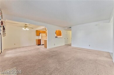 Unfurnished living room featuring light colored ca