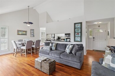 View of the entire living room, dining room, kitchen and entrance way.