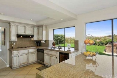 A generous sized kitchen overlooks picturesque vie