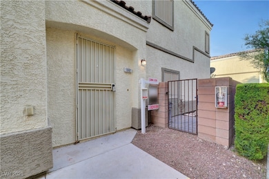 View of exterior entry with stucco siding and a ga
