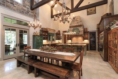 GORGEOUS DINING AND KITCHEN AREA THAT IS COMBINED WITH THE GREAT ROOM!  CONCRETE FLOORS! 9 FT ISLAND IN KITCHEN PLUS CATHEDRAL CEILING WITH RUSTIC ROUGH-HEWN BEAMS, TRUSSELS AND STONE WALLS!