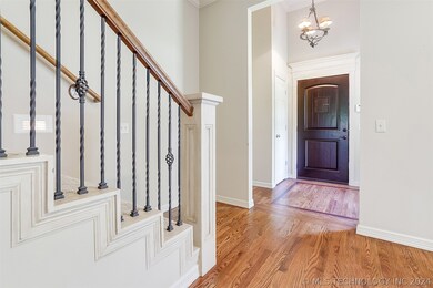 Foyer with hardwoods opens to family room.