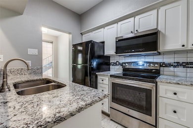 view of granite counter and stainless steel applia
