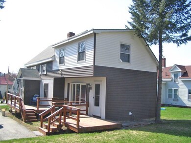 A roomy deck at the rear entrance to...