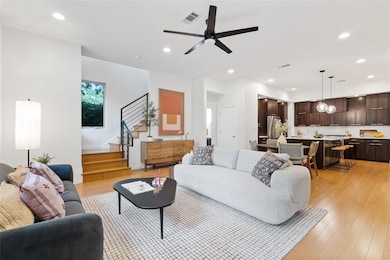 Living area with recessed lighting, stairway, and