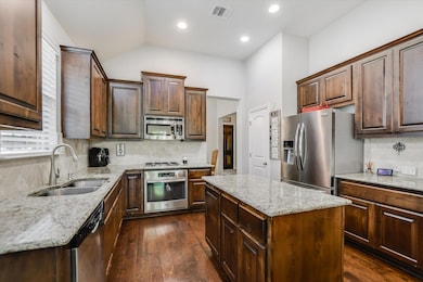 Kitchen with stainless steel appliances, a sink, 