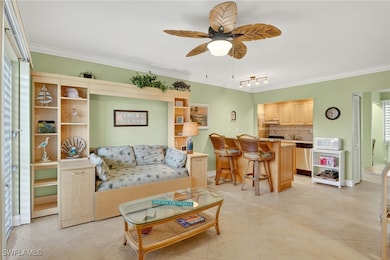 Living area featuring ornamental molding, light tile patterned floors, a ceiling fan, and rail lighting