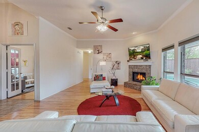 Living room with ornamental molding, a fireplace, 