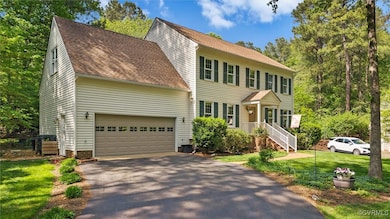 Colonial house with a garage, a shingled roof, aph