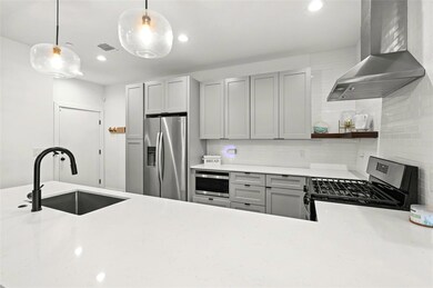 Kitchen with stainless steel appliances, wall chi