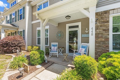 Entrance to property with covered porch and stone 