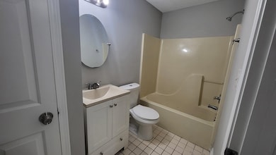 Full bathroom featuring vanity, light tile patterned floors, and tub / shower combination