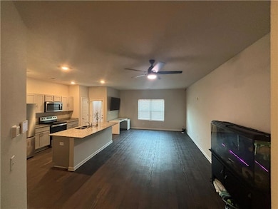 Kitchen with stainless steel appliances, dark wood