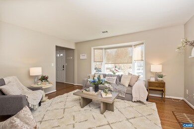 Spacious living room with bay window and gas log f