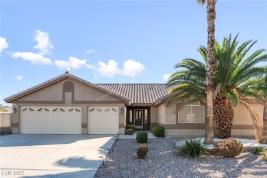 View of front of home with stucco siding, concrete driveway, a garage, and a tile roof