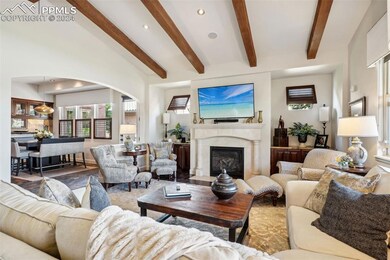 Living room featuring beamed ceiling and wood-type