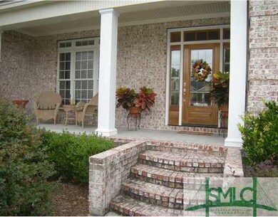 Exterior Front. Brick steps lead to glass entrance