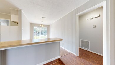 Kitchen featuring wood walls, hanging light fixtur