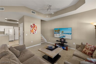 Tiled living room featuring ceiling fan