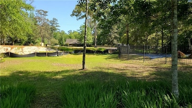 Back of lot with in ground pool.