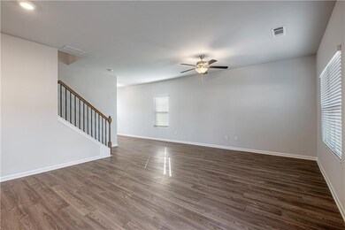 Unfurnished living room with dark hardwood / wood-