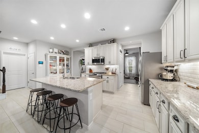 Beautiful open kitchen with SS appliances.  So muc