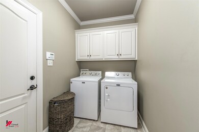Clothes washing area featuring washer and clothes 