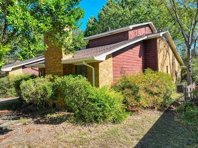 View of side of home featuring roof with shingles and a cooling unit