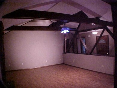 Great Room has a high valted ceiling with exposed 