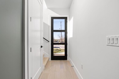 Entryway with baseboards and light wood-style flo