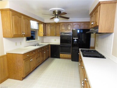 The kitchen with its solid oak cabinets offers ple